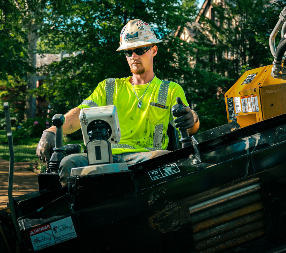 Above & Below Contracting Employee On a Machine