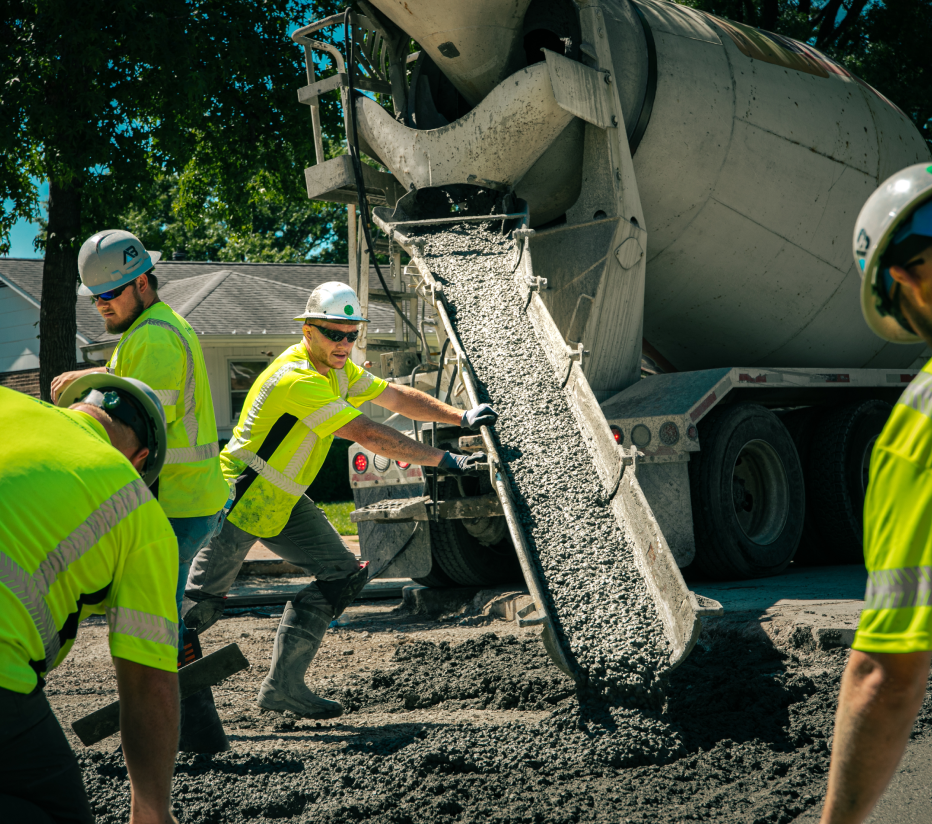 Above & Below Contracting Employees Pouring Concrete