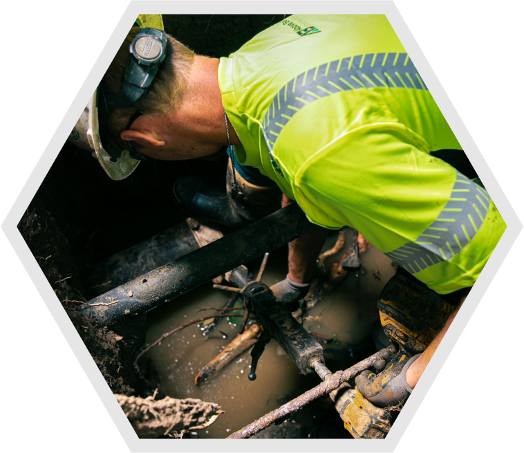 Above & Below Employee Fixing Water Main Break