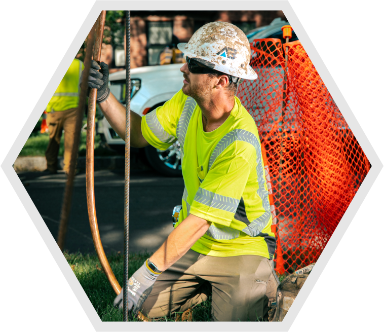 Above & Below Contracting Worker working on a water main